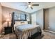 Comfortable bedroom featuring a ceiling fan, plush carpet, and modern decor at 2900 Purcell St # I4, Brighton, CO 80601