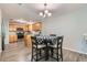 Dining room with modern chandelier, hardwood floors, and view to kitchen at 2900 Purcell St # I4, Brighton, CO 80601