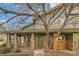 Charming two story home with a covered front porch featuring brick accents and mature landscaping at 2900 Purcell St # I4, Brighton, CO 80601