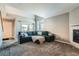 Spacious living room with plush carpeting, fireplace, and abundant natural light from the window at 2900 Purcell St # I4, Brighton, CO 80601