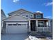 Charming two-story home with a two-car garage and covered front porch at 586 Nightsky St, Erie, CO 80516