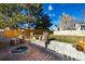 Landscaped backyard with firepit and wood storage at 16357 E Wyoming Dr, Aurora, CO 80017