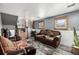 Finished basement with brown leather sofas and a wood-look floor at 16357 E Wyoming Dr, Aurora, CO 80017