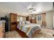 Spacious main bedroom with wood furniture and ceiling fan at 16357 E Wyoming Dr, Aurora, CO 80017