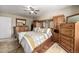 Main bedroom with large bed and built-in wood storage at 16357 E Wyoming Dr, Aurora, CO 80017