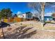 House exterior with gray siding, rock landscaping, and wood fence at 16357 E Wyoming Dr, Aurora, CO 80017