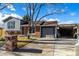 House exterior featuring brick and gray siding, a driveway, and landscaping at 16357 E Wyoming Dr, Aurora, CO 80017