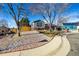 House exterior with gray siding, rock landscaping, and wood fence at 16357 E Wyoming Dr, Aurora, CO 80017