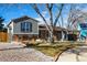 Gray sided home with brick base, landscaped yard, and a rock pathway at 16357 E Wyoming Dr, Aurora, CO 80017