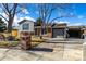 Brick ranch home with gray siding, landscaped yard, and attached garage at 16357 E Wyoming Dr, Aurora, CO 80017