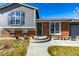 House exterior featuring brick and gray siding, a walkway, and landscaping at 16357 E Wyoming Dr, Aurora, CO 80017