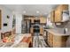 Modern kitchen featuring stainless steel appliances and wood cabinets at 16357 E Wyoming Dr, Aurora, CO 80017