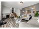 Open living area with grey sofas, a wooden coffee table, and stairs at 16357 E Wyoming Dr, Aurora, CO 80017