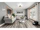 Bright living room featuring grey sofas and wood-look floors at 16357 E Wyoming Dr, Aurora, CO 80017