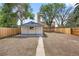 View of backyard and shed with modern trim, blue accents, and new wood fence at 851 S Eliot St, Denver, CO 80219
