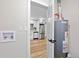 Unfinished basement with a utility sink, water heater, and entry to the kitchen at 851 S Eliot St, Denver, CO 80219