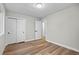 A bright bedroom showcasing new wood floors, white walls, and closet at 851 S Eliot St, Denver, CO 80219