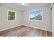 Bright bedroom with two windows providing natural light and wood flooring at 851 S Eliot St, Denver, CO 80219