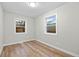 Empty room featuring neutral walls, wood flooring, and a window at 851 S Eliot St, Denver, CO 80219