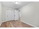 Spacious bedroom featuring wood floors, closet, and a view to another room at 851 S Eliot St, Denver, CO 80219
