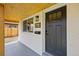 Close-up of the front porch with a newly painted door and modern light fixture at 851 S Eliot St, Denver, CO 80219