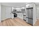Modern kitchen with stainless steel appliances, white cabinets, and subway tile backsplash at 851 S Eliot St, Denver, CO 80219