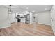 A spacious open concept floor plan with kitchen, dining, and living room, and wood floor at 851 S Eliot St, Denver, CO 80219