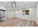 Bright room featuring new laminate flooring, modern lighting and fresh paint at 851 S Eliot St, Denver, CO 80219