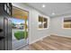 Bright room featuring new laminate flooring, windows and fresh paint at 851 S Eliot St, Denver, CO 80219