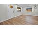 Bright room featuring new laminate flooring, windows and fresh paint at 851 S Eliot St, Denver, CO 80219