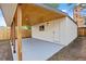 View of backyard shed, which features concrete slab, wood trim, and fresh paint at 851 S Eliot St, Denver, CO 80219