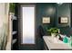 The bathroom features a modern sink, shelving, and a window, all in a dark motif at 610 Meadow View Dr, Evergreen, CO 80439