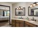 Bathroom with granite countertops, double sinks, and access to bedroom view at 610 Meadow View Dr, Evergreen, CO 80439