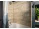 This bathroom boasts elegant beige tile, a shower-tub, and stylish fixtures at 610 Meadow View Dr, Evergreen, CO 80439