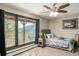The bedroom offers rustic beds, mountain views, and natural light through a large window at 610 Meadow View Dr, Evergreen, CO 80439