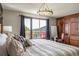 Bright bedroom featuring a king bed and exterior view at 610 Meadow View Dr, Evergreen, CO 80439