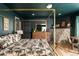 This bedroom provides wood floors, a stone fireplace, a canopied bed, and views of the outdoors at 610 Meadow View Dr, Evergreen, CO 80439