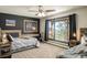 Bedroom with a ceiling fan and large windows that frame mountain scenery outside at 610 Meadow View Dr, Evergreen, CO 80439