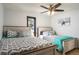 Bright bedroom featuring two beds, natural light, and coordinating chevron patterns at 610 Meadow View Dr, Evergreen, CO 80439