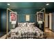 The primary bedroom showcases a forest-themed bed, striking artwork, and a cozy ambiance at 610 Meadow View Dr, Evergreen, CO 80439
