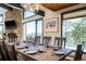 Mountain view seen from dining room with wood table and stone wall at 610 Meadow View Dr, Evergreen, CO 80439