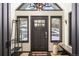 Welcoming foyer features a stylish door flanked by windows, offering a glimpse of the snow covered outdoors at 610 Meadow View Dr, Evergreen, CO 80439