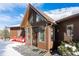 Inviting front entrance with a unique peak roof and a warm wood facade, showcasing a cozy and welcoming exterior at 610 Meadow View Dr, Evergreen, CO 80439