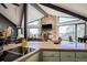 Bright, open-concept kitchen with an island cooktop, granite countertops, and cozy views of the fireplace in the living room at 610 Meadow View Dr, Evergreen, CO 80439