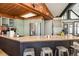 Open kitchen with a large island, stainless steel appliances, and light green cabinetry for a welcoming and functional space at 610 Meadow View Dr, Evergreen, CO 80439