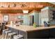 Spacious kitchen with an island and bar seating, stainless steel appliances, wooden walls and stylish decor, ideal for entertaining at 610 Meadow View Dr, Evergreen, CO 80439