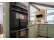 Modern kitchen with an oven, granite countertops, wooden cabinets, and a window view at 610 Meadow View Dr, Evergreen, CO 80439
