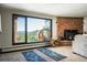 Living room features a fireplace, yoga mats, and mountain views at 610 Meadow View Dr, Evergreen, CO 80439
