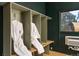 Locker room area showcasing wood benches, individual storage, bathrobes, and mountain views at 610 Meadow View Dr, Evergreen, CO 80439