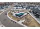 Aerial view of a community pool, playground, and manicured grounds at 7484 W Atlantic Ln, Denver, CO 80227